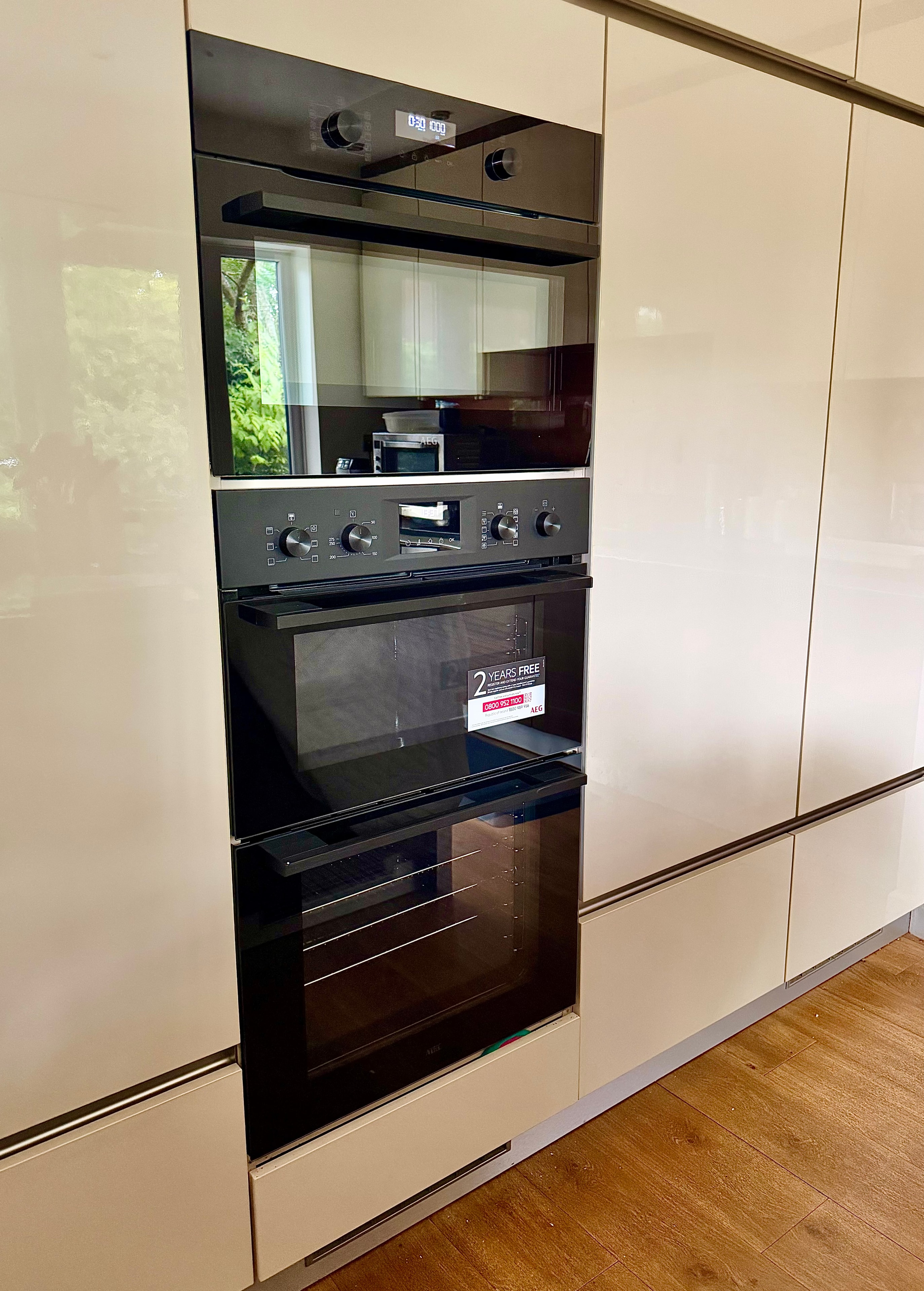 AEG oven and microwave with doors open showing interior